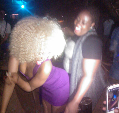 Sheebah being rub-a-dubbed by a friend.