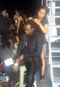 Zuena working on Bebe Cool's hair on the set. 