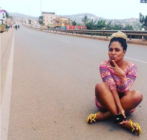 A young lady poses on the empty streets. When was Entebbe Road ever like this???