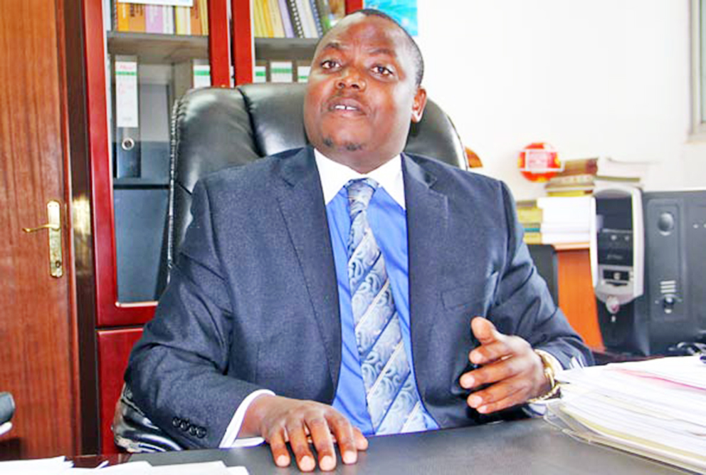 Minister Kibuule in his office. 