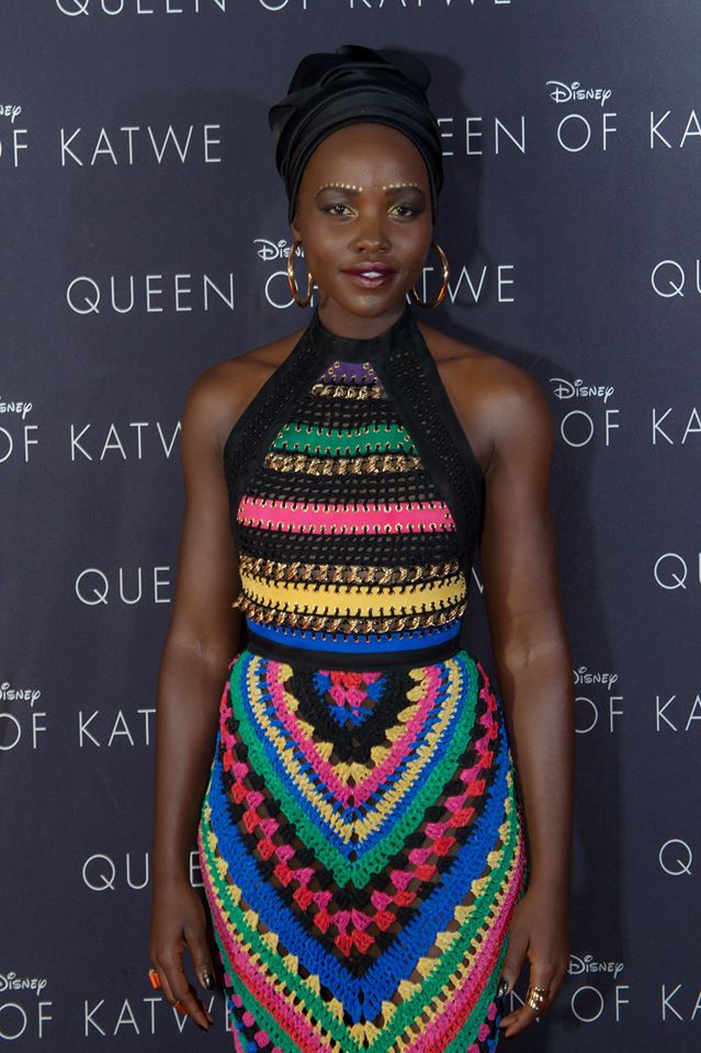 Lupita at the South African premiere of Queen of Katwe. With too much colour going on in her knit dress, she chose to tone down with a black head wrap.