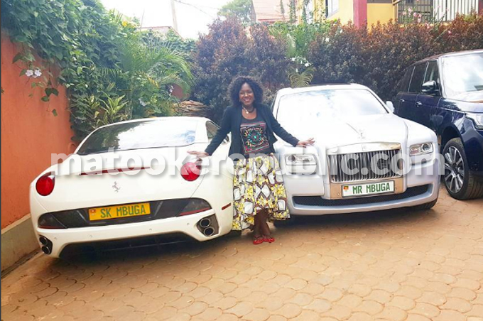 Wedding plane Sylvia Owori poses by the bridal cars. 
