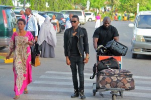 Diamond's mother, the star and an aide at Dar Es Salaam Airport. 