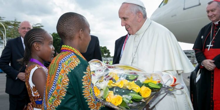 The Pontiff receives a bouquet of flowers at JKIA. This is his first visit to Africa.