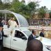 The Pope waves to believers at Namugongo.