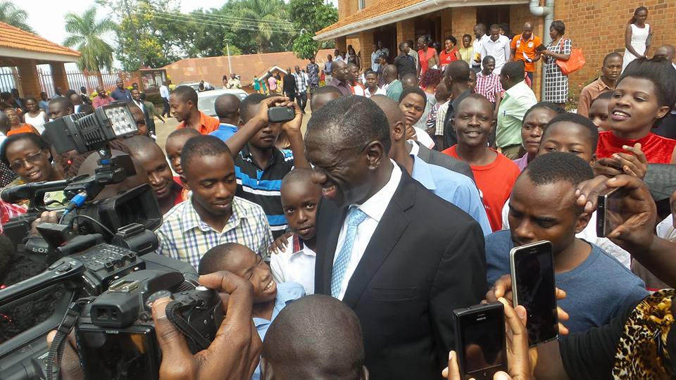 Besigye mobbed by press and other church-goers after the service.