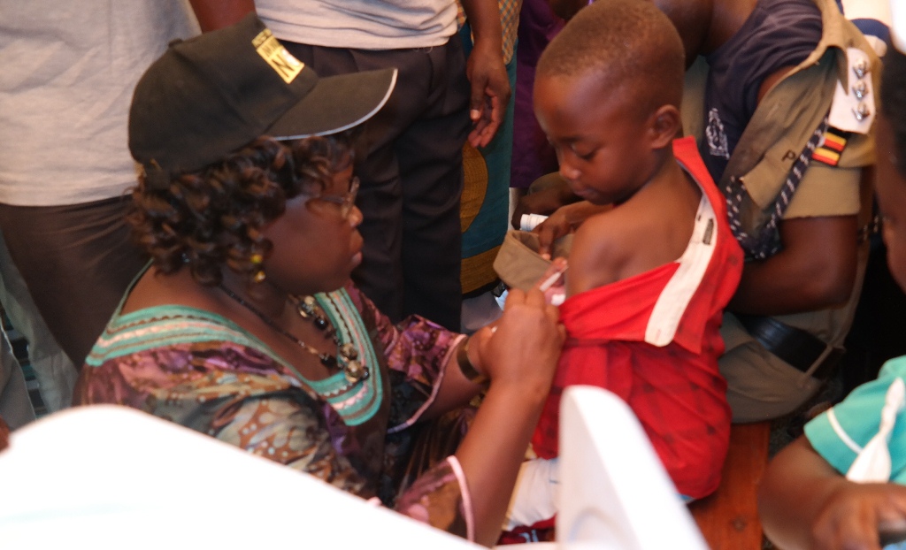 Hon. Dr. Moriku Joyce Odoki, Minister of State Primary Health Care immunizes a child during the launch of a free mass immunization campaign against Meningitis A (MEN A) in Omoro District on 17th January 2016. The campaign that will traverse 39 high risk districts in Uganda has been organized by the Ministry of Health in collaboration with World Health Organisation and partners.