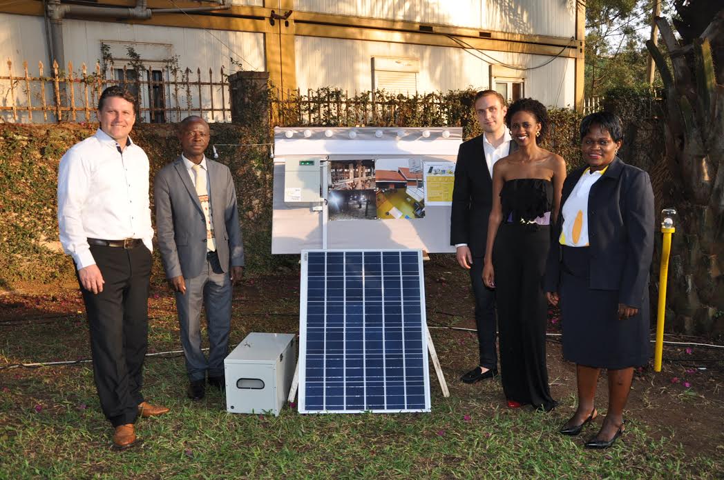 (L-R) Village Power Uganda CEO, Thomas Huth, Commissioner for Renewable Energy John Tumuhimbise, Simon Koch; COO Village Power, Sumaya Kiwanuka; Head of Human Resources and Communication, Village Power and Lilian Babona; Country Manager, Village Power pose besides one of the Company's solar panels and products.