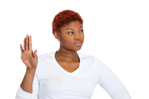 Closeup portrait of young annoyed woman with bad attitude giving talk to hand gesture with palm outward isolated on white background. Negative emotion facial expression feeling body language, reaction