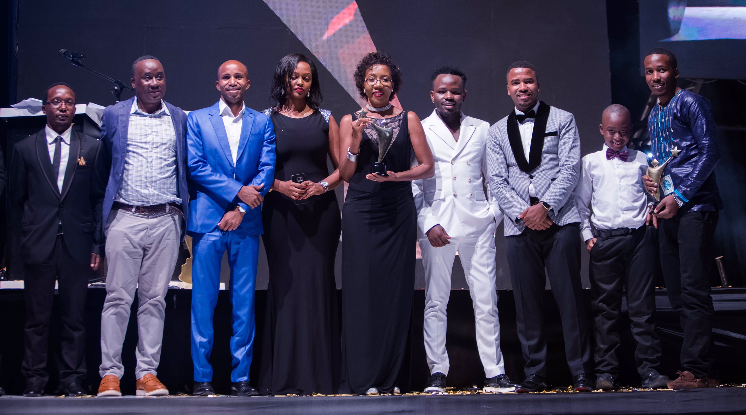 Vodafone Marketing Director, Progress Chisenga (2nd right) holding and representing the overall Young Achiever Award poses for a picture with (left –right) Founder of the Awards Awel Uwihanganye; Social Entrepreneurship Award winner Muhammed Kisirisa aka Slum Ambassador; Fiona Kayitesi, Vodafone Youth Program Manager; Creative Arts-Fashion Award winner Brian Ahumuza of Abryanz Collection; and Humphrey Nabimanya, the Team Leader & Founder of Reach A Hand Uganda at the prestigious 2017 Young Achievers Awards recently.