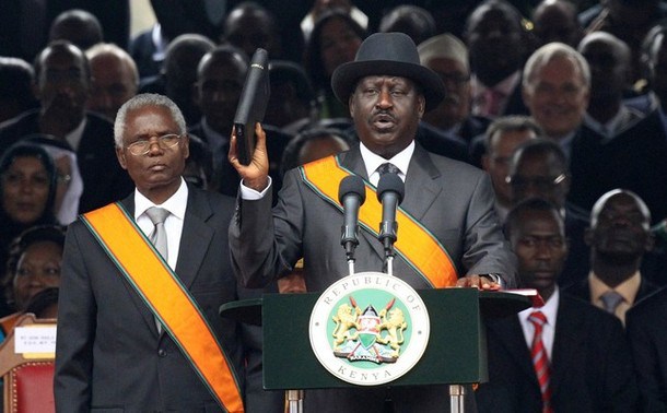 Kenya's Prime Minister Raila Odinga takes the Oath of Allegience and due execution of office under the new constitution during the promulgation of the new constitution at the Uhuru Park grounds in Nairobi August 27, 2010. Kenya turned a blind eye to its duty to arrest Sudanese President Omar Hassan al Bashir, who faces charges of genocide, when the Sudanese leader arrived for the promulgation of Kenya's new constitution on Friday. REUTERS/Thomas Mukoya (KENYA - Tags: CRIME LAW POLITICS)