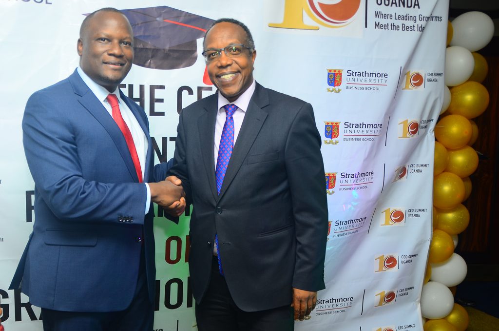 Dr George Njenga executive Dean Strathmore University  hangs with the night's Keynote speaker DFCU’s Managing Director Mathias Katamba at the graduation on yesterday.