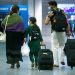 A family walks with their bags upon arrival at Frankfurt Airport, Germany, August 18, 2021, after being evacuated from Kabul, Afghanistan. REUTERS/Thilo Schmuelgen