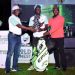 Cwinya-ai (M) receives the winner's trophy from UBL Supply Chain Director Alfred Balikagira (L) and Uganda Golf Union President Moses Matsiko.