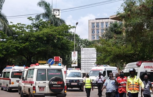Ambulances wait next to the explosion near the building of Parliament in Kamapala, Uganda, on November 16, 2021. - Two explosions hit Uganda's capital Kampala on November 16, 2021, injuring a number of people in what police termed an attack on the city, the latest in a string of blasts targeting the country. The explosions occurred in the central business district of Kampala near the central police station and the entrance to parliament, police said. (Photo by Sumy SADRUNI / AFP) (Photo by SUMY SADRUNI/AFP via Getty Images)