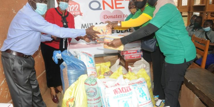 Pius Oketcho, the Headteacher of Mulago School for the Deaf received the donated items from QNET's representatives.