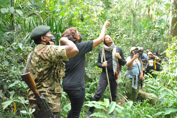 L-R: UWA ranger, UTB CEO Lilly Ajarova (2nd left), Terrence Howard (centre) and other officials tracking chimpanzees in Kibale National Park on Saturday.