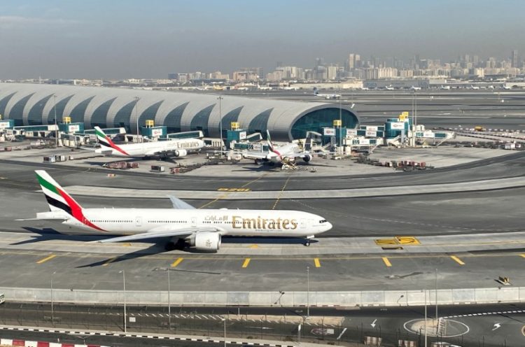 FILE PHOTO: Emirates airliners are seen on the tarmac in a general view of Dubai International Airport in Dubai, United Arab Emirates January 13, 2021. Picture taken through a window. REUTERS/Abdel Hadi Ramahi