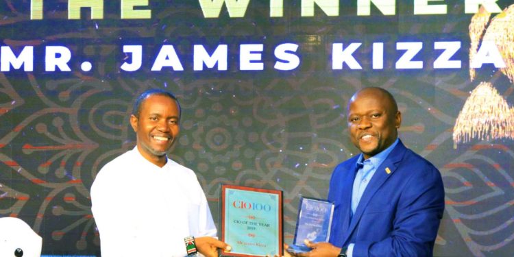 James Kizza (right) Assitant Commissioner URA receiving the East Africa's CIO of the Year Award 2019 from Joe Mucheru, Kenya's ICT Cabinet Secretary.