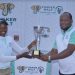 Mark Ethan Kamanyire, Key Accounts Manager UBL hands over the winning trophy to Martha Babirye, the three time title holder of the Tusker Malt Uganda Ladies Open at the Lake Victoria Serena Golf and Spa, Kigo.