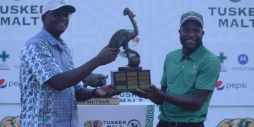 Managing Director UBL Andrew Kilonzo hands over the trophy to the winner of the Tusker Malt Uganda Golf Professionals Open, Robson Chinhoi at the recently concluded tournament.