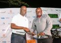 Acting Managing Director I&M Bank Sam Ntulume presents a golf club to Robert Ejiku.