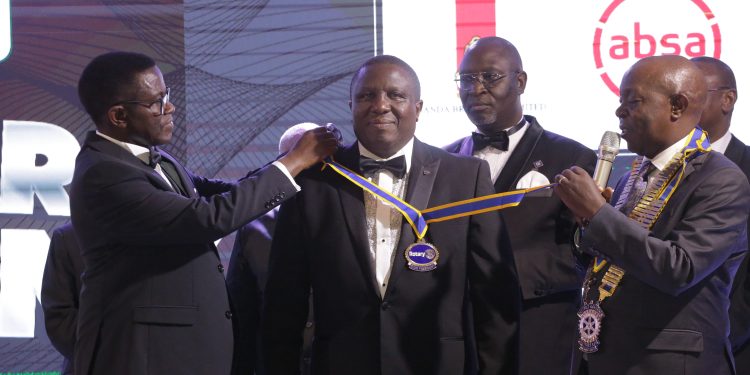 UBL’s Jimmy Mugerwa getting installed as the new Charter president of the Rotary Club of Kigo Seven Lakes Gold.