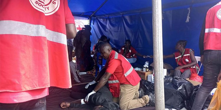 Red Cross officials providing aid to injured pilgrims.