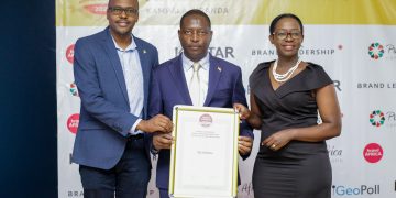 L-R UBL's Marketing & Innovation Director Emmy Hashakimana, Minister of state for Trade, Industry and Cooperatives David Bahati  and UBL's Jackie Tahakanizibwa the corporate Relations, Public Policy & Regulatory Affairs Manager  Pose for a photo after receiving the award.