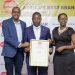L-R UBL's Marketing & Innovation Director Emmy Hashakimana, Minister of state for Trade, Industry and Cooperatives David Bahati  and UBL's Jackie Tahakanizibwa the corporate Relations, Public Policy & Regulatory Affairs Manager  Pose for a photo after receiving the award.