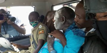 Patrick Amuriat (wearing blue) after being arrested by police during 2021 presidential campaigns.