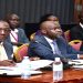 L-R:Chairperson of the Board of UNBS, Charles Musekuura and Executive Director of UNBS David Livingstone Ebiru (middle) appearing before COSASE.