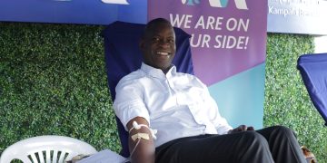 Sam Ntulume, the Managing Director of I&M Bank donating blood.