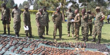 UPDF officers led by Maj Gen Olum displaying a catchment of the weaponry and equipment captured from the ADF.