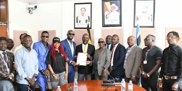 Musicians handing over their petition to Deputy Speaker of Parliament Thomas Tayebwa.