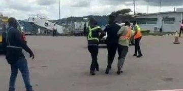 Bobi Wine dragged by security operatives at Entebbe International Airport.