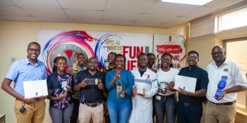 Uganda Breweries Limited staff pose with the Gold Monde Awards won by the Uganda Waragi brands.