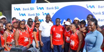 Executive Director & Chief Operations Officer I&M Bank Sam Ntulume poses for a Photo with the Katikiro of Buganda Owek.Charlse Peter Mayiga (Center),  Annette Nakyiga Head of Marketing and corporate communications  (extreme right) and other I&M Bank staff during the run earlier today.