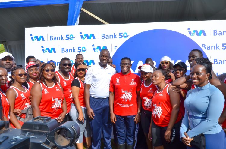 Executive Director & Chief Operations Officer I&M Bank Sam Ntulume poses for a Photo with the Katikiro of Buganda Owek.Charlse Peter Mayiga (Center),  Annette Nakyiga Head of Marketing and corporate communications  (extreme right) and other I&M Bank staff during the run earlier today.