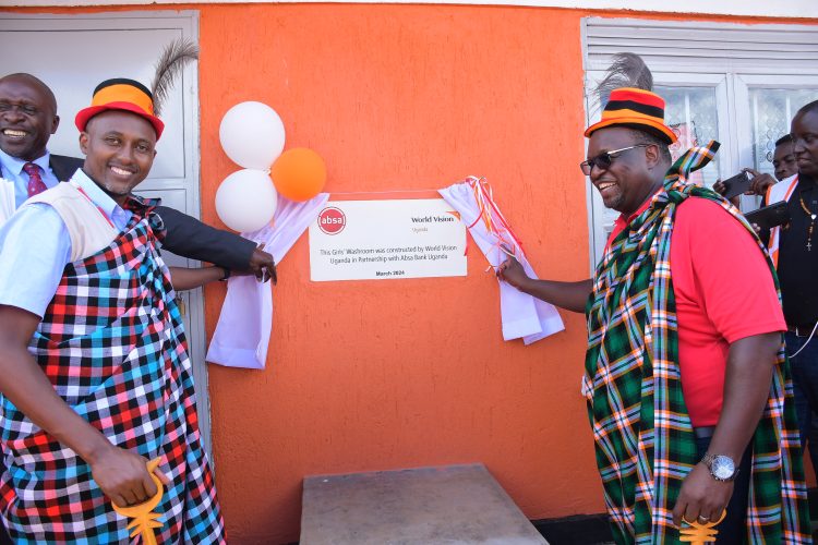 Absa MD Mumba Kalifungwa(right) and World Vision official during the commissioning.