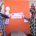 Absa MD Mumba Kalifungwa(right) and World Vision official during the commissioning.