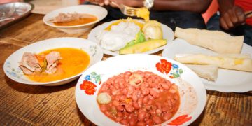 Traditional Ugandan food consisting of goat meat, cassava, potato, beans, maize meal, sweet potato, Uganda, Africa