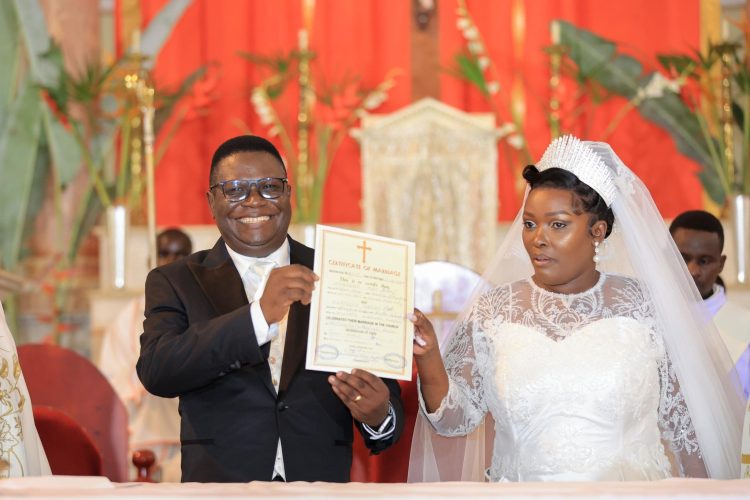 Minister Norbert Mao and his wife, Beatrice Kayanja, displaying their marriage certificate.