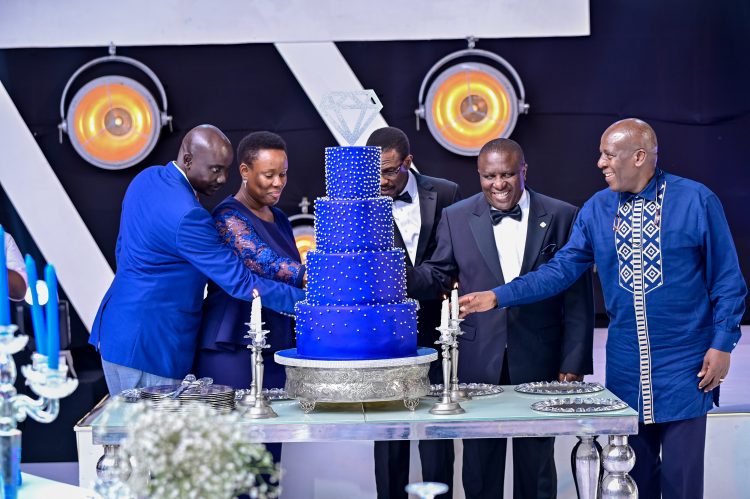 dfcu Bank management, and Guest of honor cutting cake during dfcu bank's 60 year anniverssary celebrations at Mestil Hotel.
