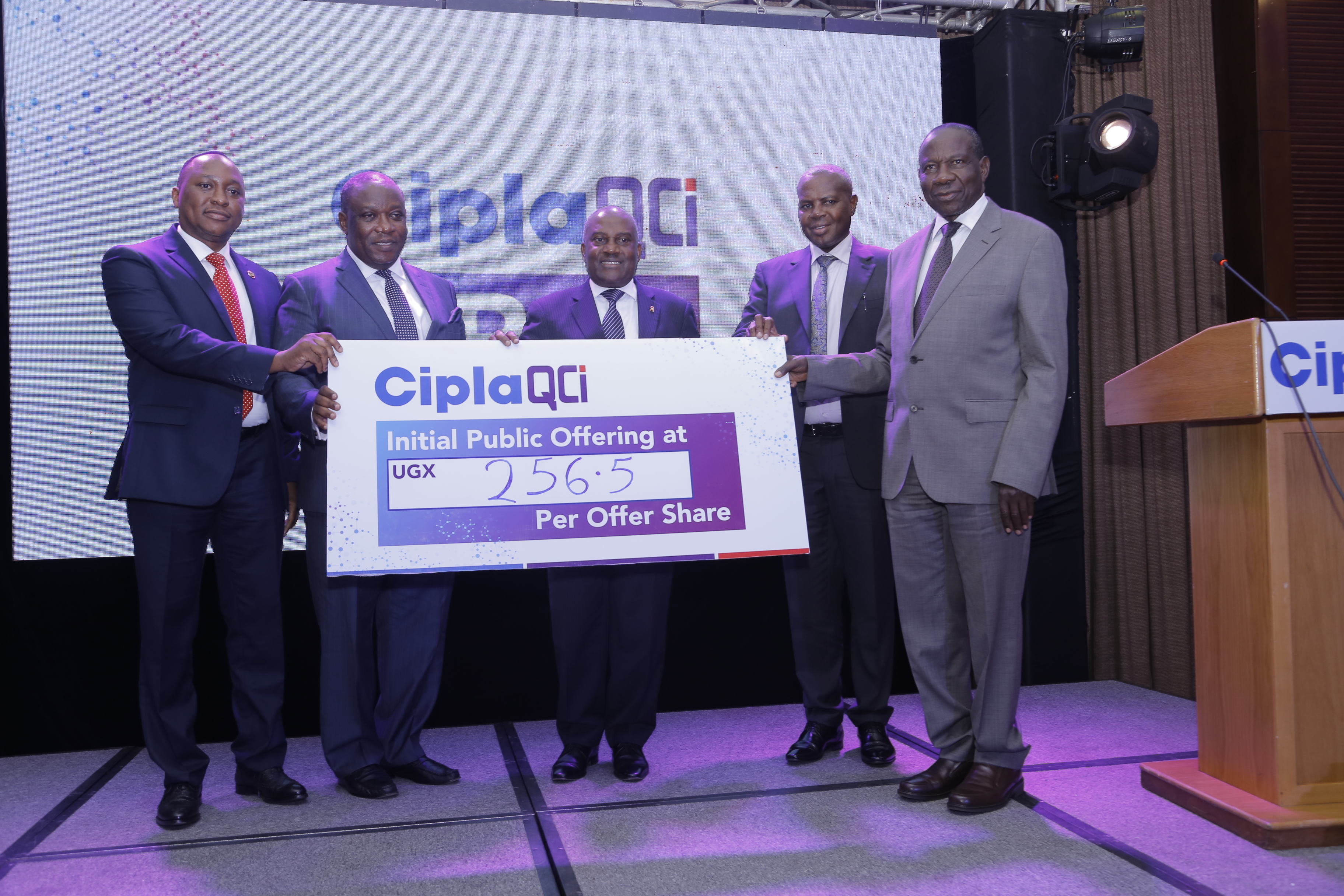 Hon. Matia Kasaija, Minister for Finance (Right) and Mr. Emmanuel Katongole, Executive Chairman Cipla Quality Chemical Industries Limited (middle) flanked by other officials unveil the CiplaQCIL Initial Public Offer Share price