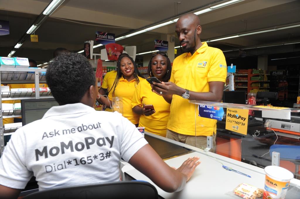 Martin-Sebuliba-Senior-Manager-Brand-Communications-at-MTN-Uganda-prepares-to-pay-for-his-shopping-using-MoMoPay-at-Masters-Supermarket-in-Ntinda