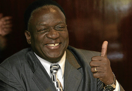 Emmerson Mnangagwa of Zimbabwe's President Robert Mugabe ZANU-PF ruling party shows a thumb-up to Morgan's election agent Chris Mbanga at the verification room at a Harare hotel May 1, 2008 during a key meeting at which Zimbabwe's Electoral Commission was to present candidates with initial results from a March 29 presidential poll. President Robert Mugabe was represented at the meeting by Rural Housing Minister Emmerson Mnangagwa and opposition leader Morgan Tsvangirai was represented by his election agent Chris Mbanga. AFP PHOTO / Alexander Joe (Photo credit should read ALEXANDER JOE/AFP/Getty Images)